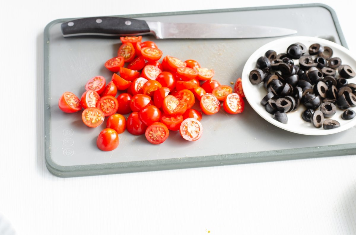 Slices of olives and cherry tomatoes to use in chickpea salad