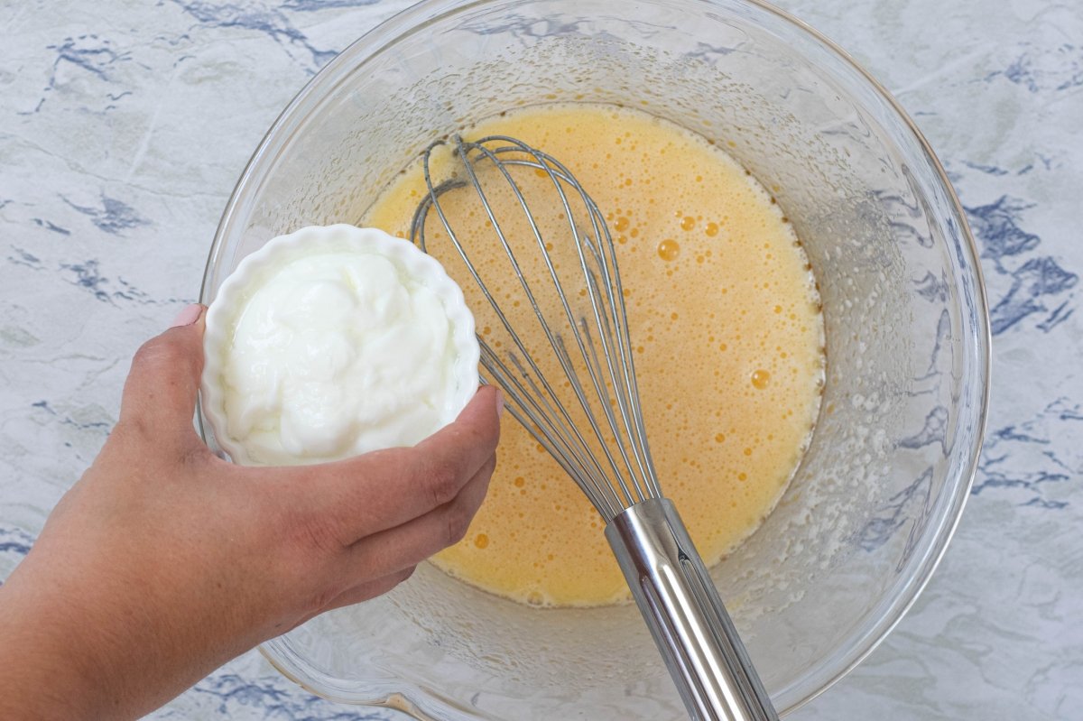 Add the yogurt to the homemade lemon sponge cake