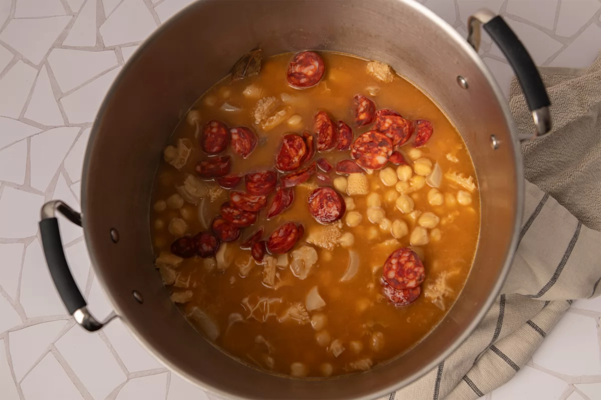 Agregando chorizo a los callos con garbanzos