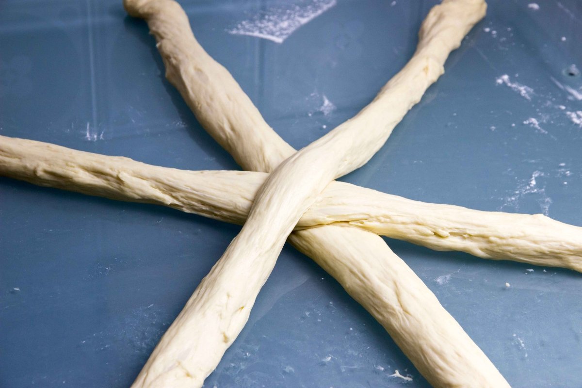 Roll out the portions of dough for the Challah bread and arrange to make a braid