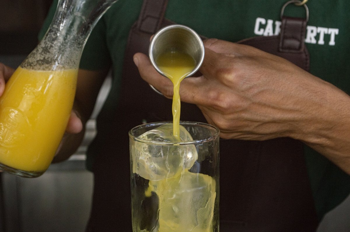 Adding the orange juice to the Tequila Sunrise
