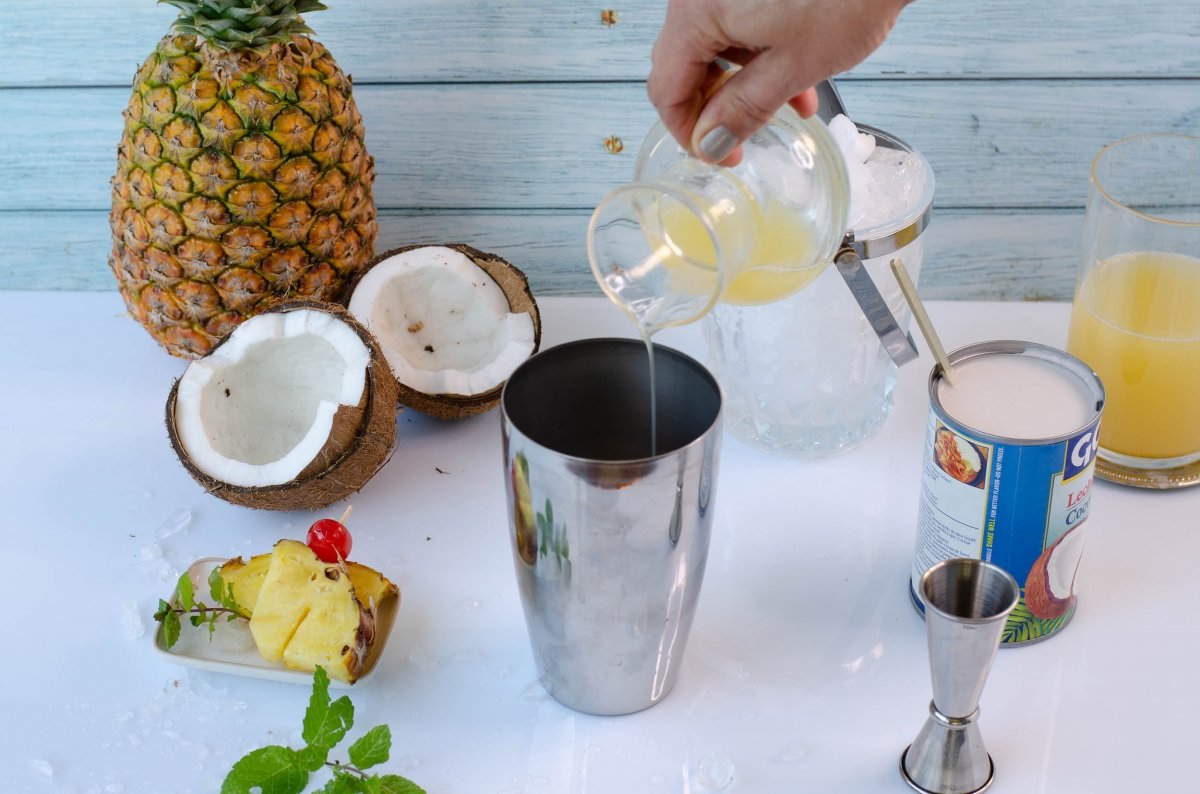 Adding the ingredients to make the pina colada