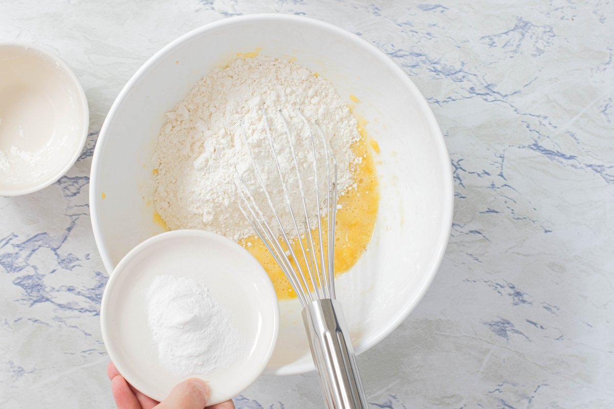 Add flour and baking powder to banana pancakes