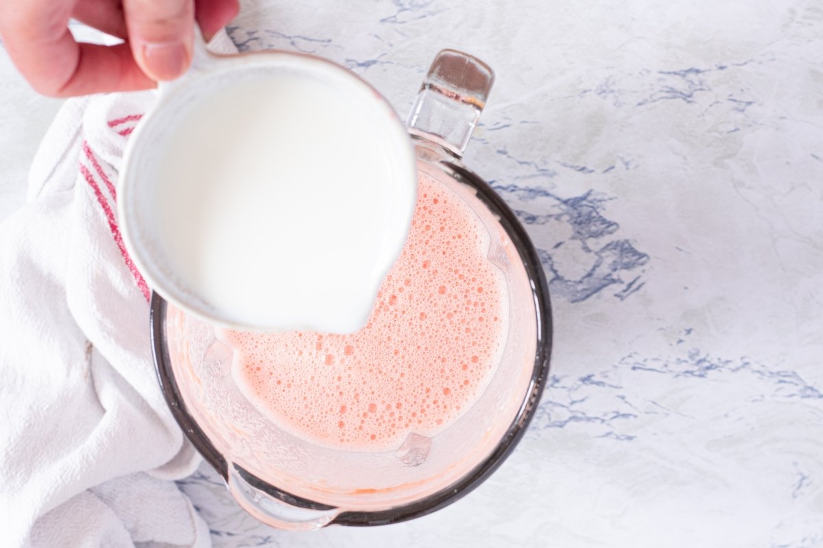 Add the milk to the watermelon smoothie