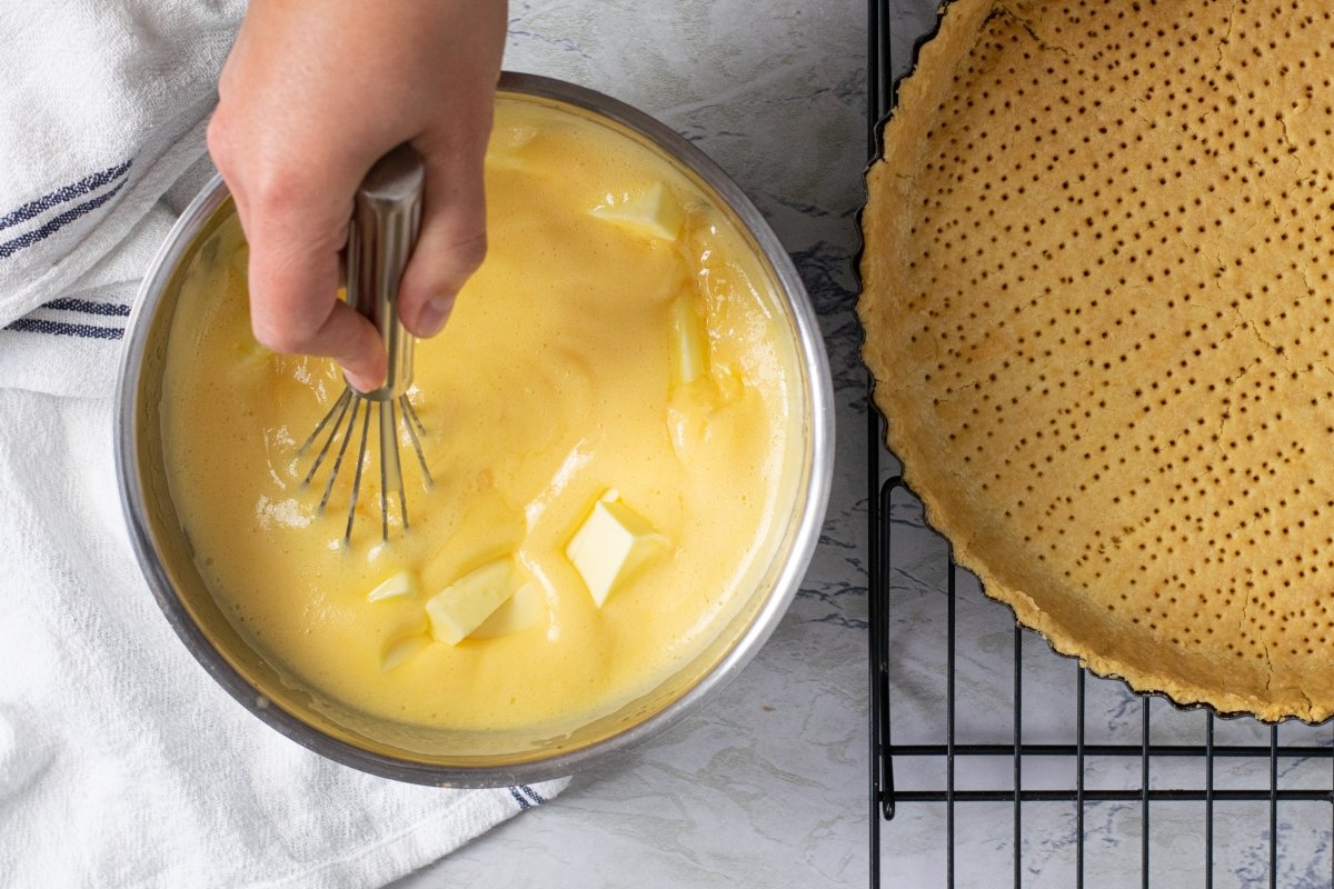 Add the butter to the lemon tart filling