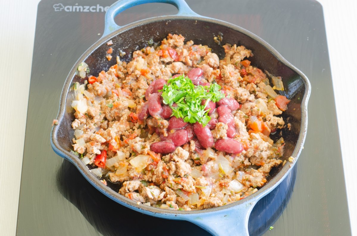 Añadimos las alubias rojas y el cilantro al relleno de las chimichanga