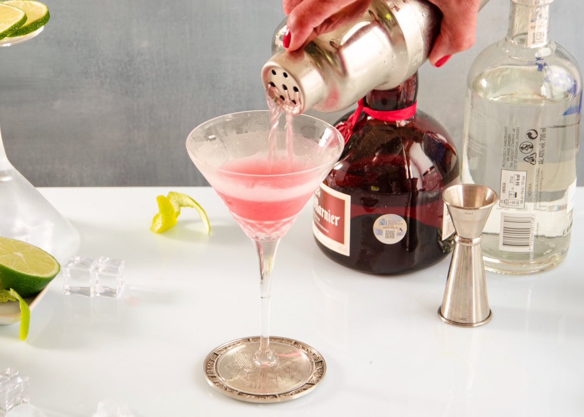 We add a cherry to the cocktail
