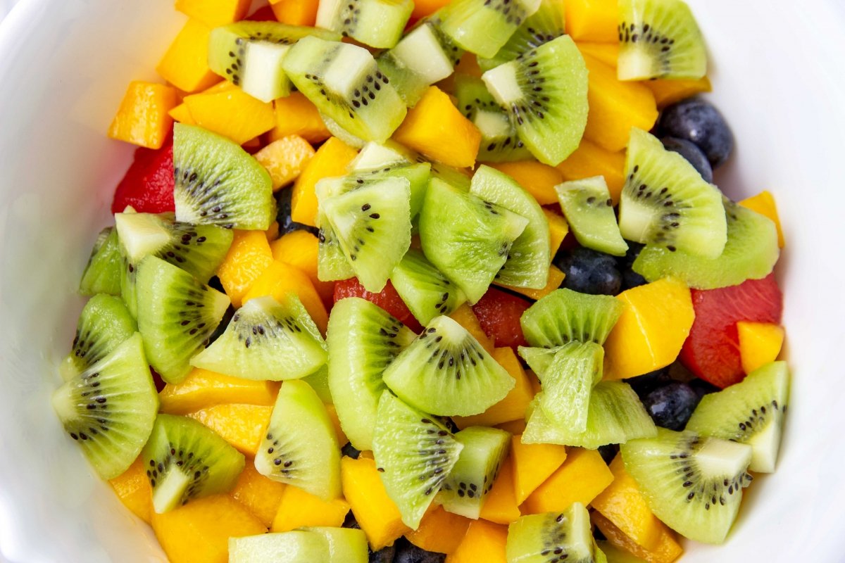 Add the peach and kiwi to the fruit salad