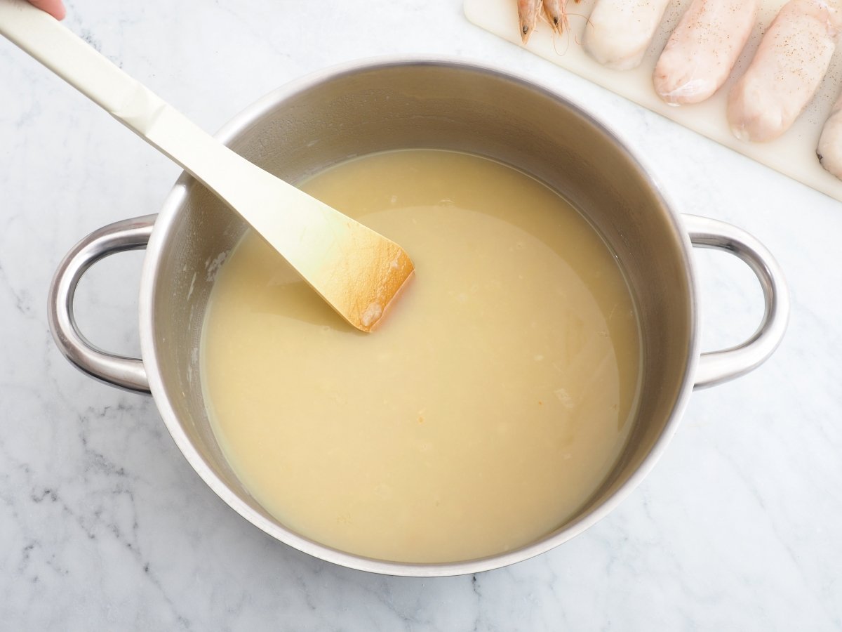 Añadir el fumet para la merluza con gambas
