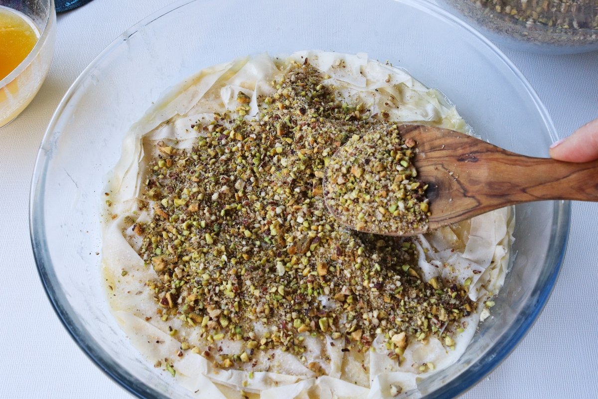 Add the layer of ground pistachios for the baklava
