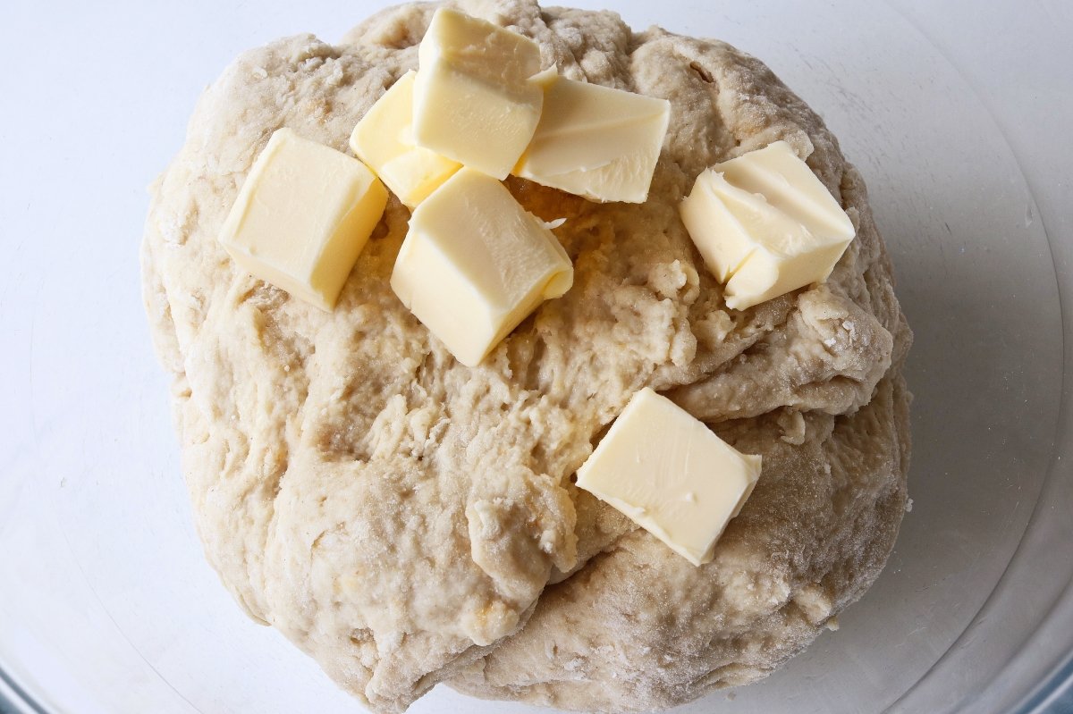 Add the butter to the dough for the cheese bread
