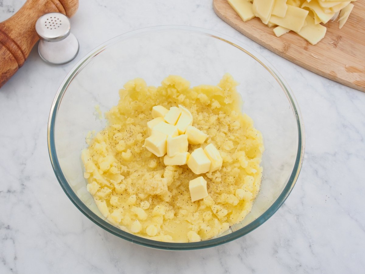 Añadir la mantequilla al puré de patatas para el aligot