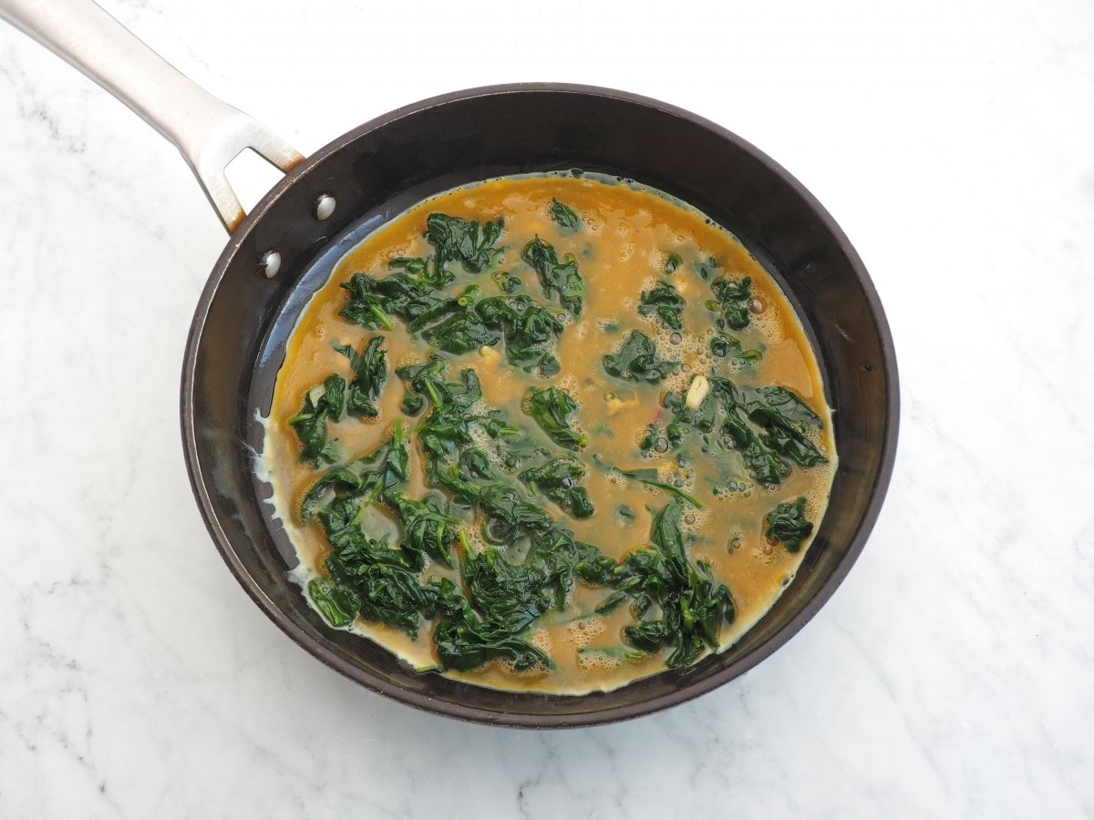 Añadir los huevos batidos para el revuelto de espinacas