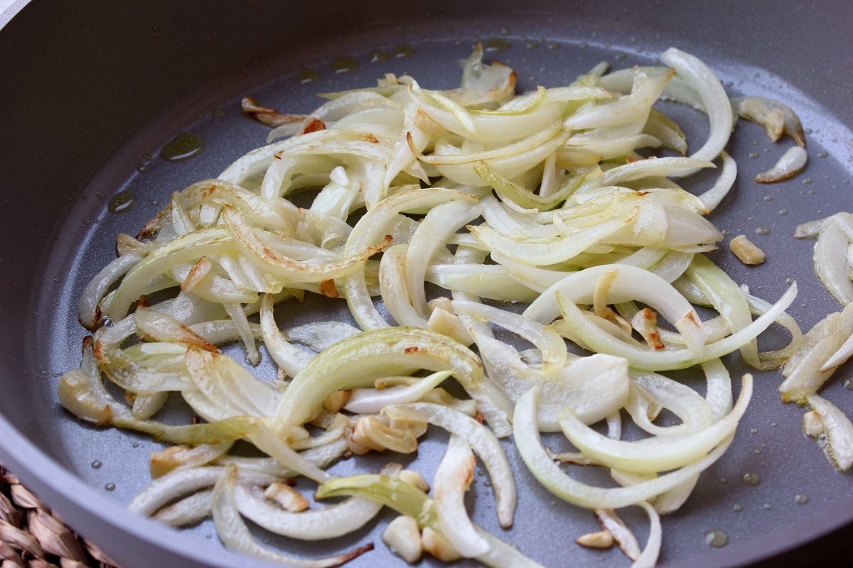 Aspecto de la cebolla y el ajo pochado para hacer la piperrada