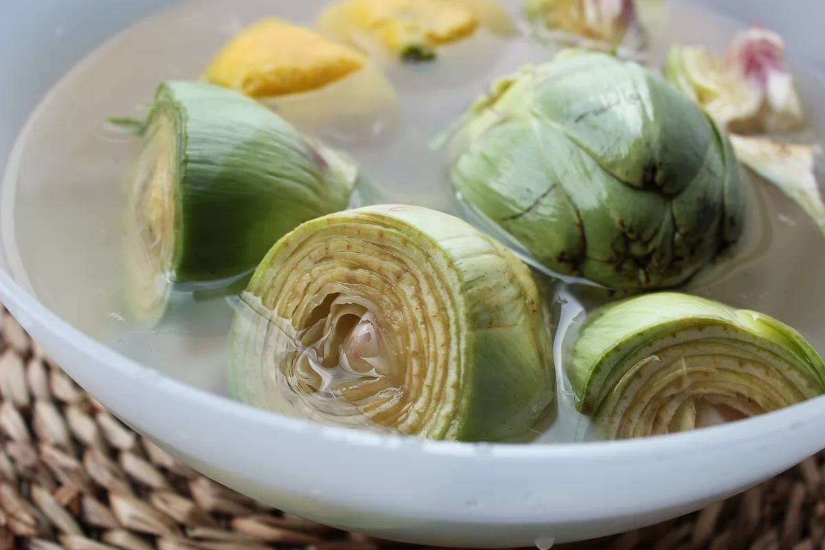 Alcachofas rebozadas 3 Bol con agua y limón con las alcachofas sumergidas *
