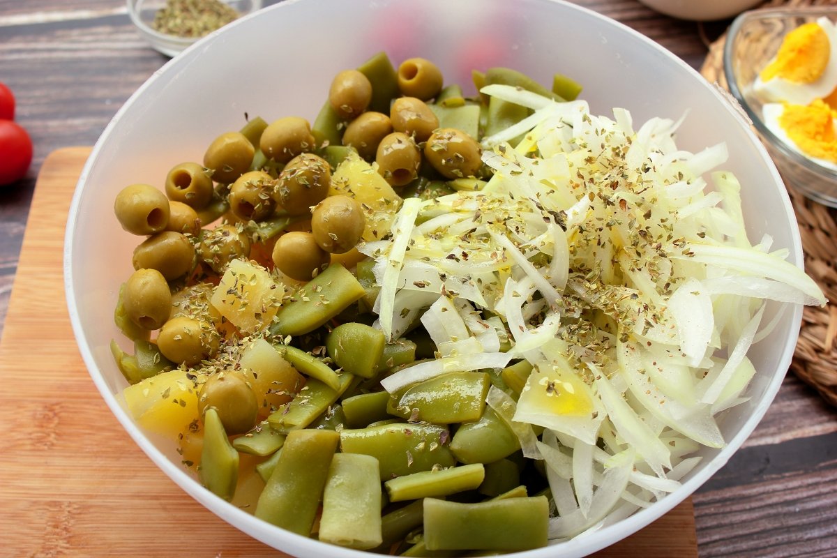 Bowl with green bean and potato salad ingredients