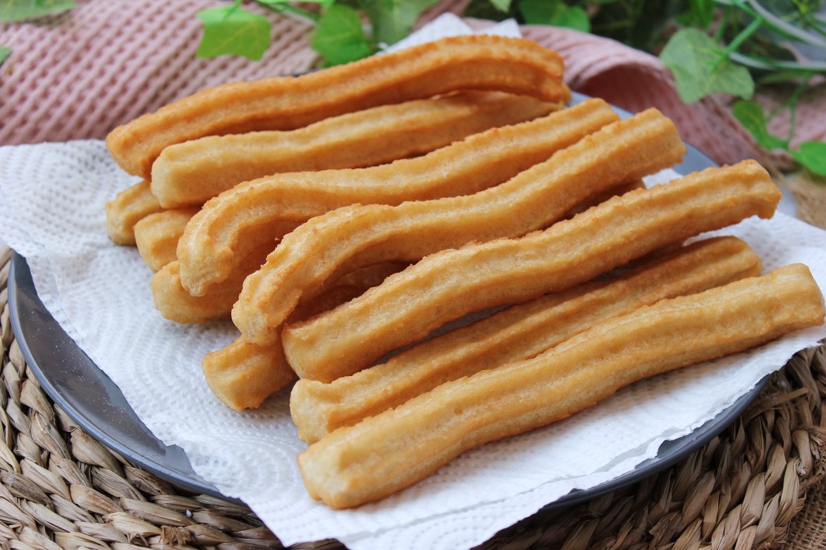 Homemade churros on absorbent paper