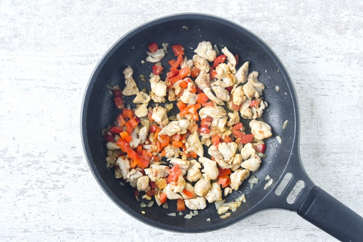 Cocinamos el pollo con el pimiento, la cebolla y el ajo