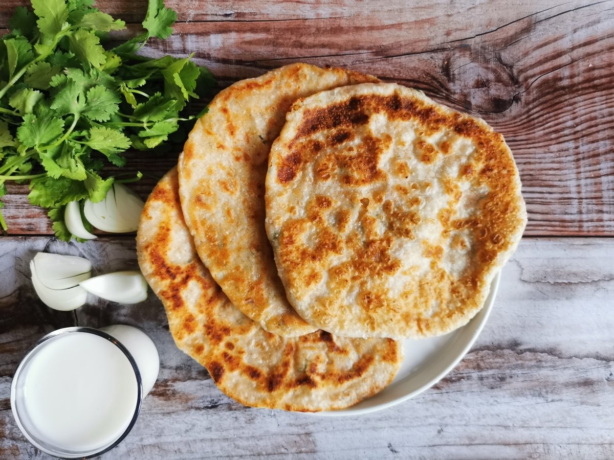 cook the parathas over medium high heat, brushing them first with sunflower oil