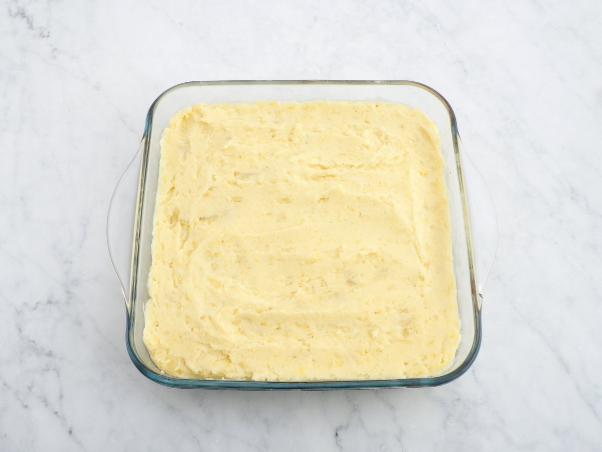 Cubrir el cottage pie con el puré de patata