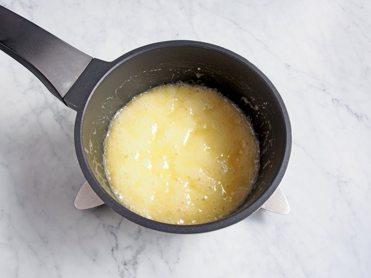 Derretir la mantequilla con el azúcar para la tarta Tatin de nísperos
