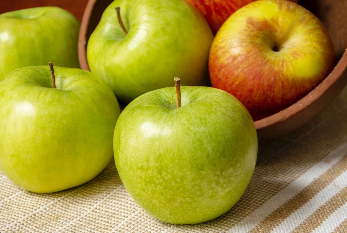 Diferentes tipos manzanas sobre una mesa