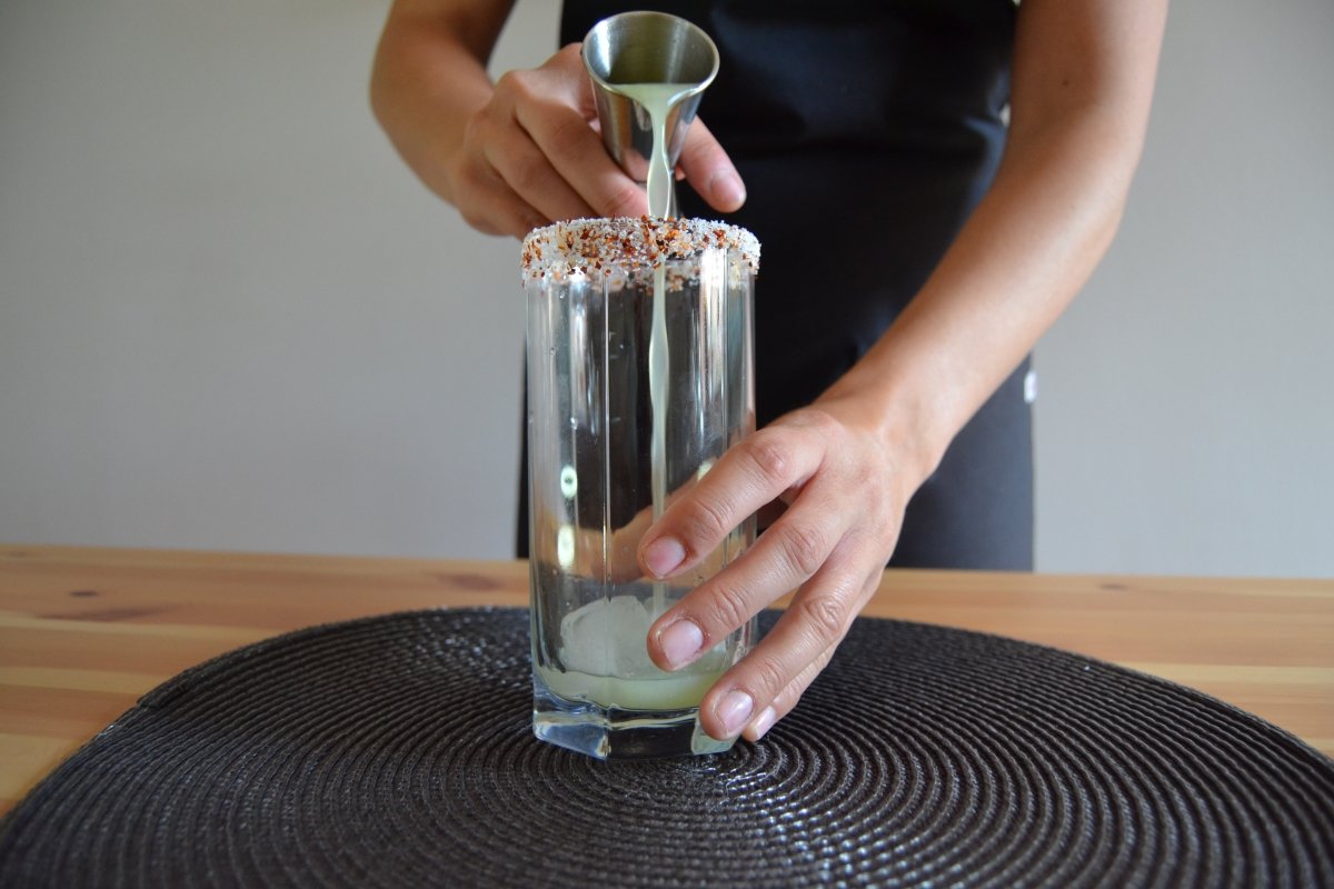 Pour the lime juice into the glass