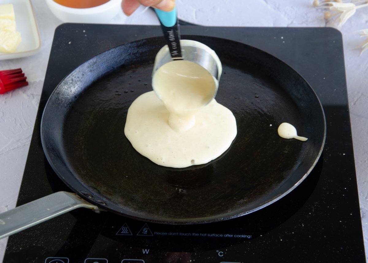Pouring the pancake batter into the pan