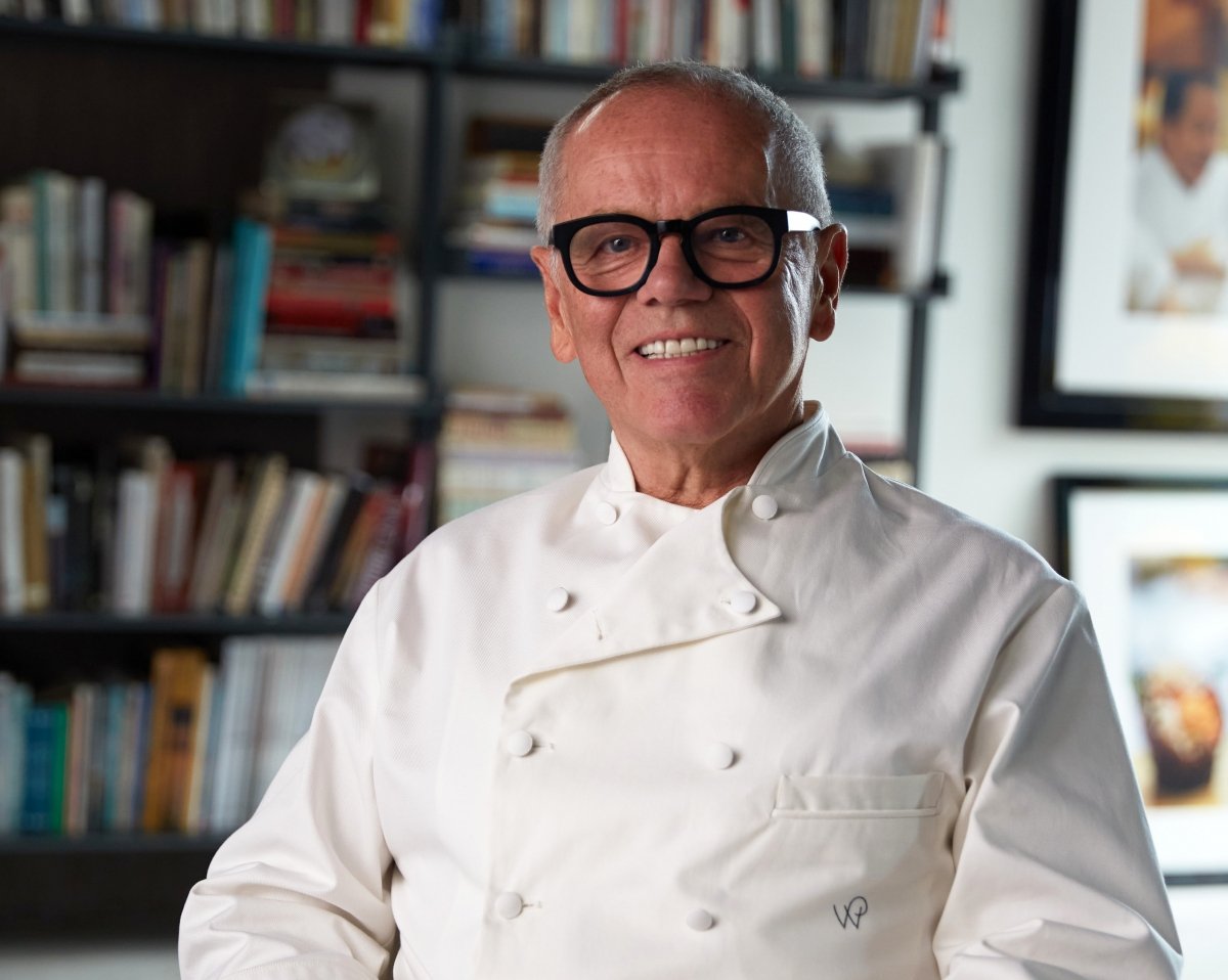 Chef Wolfgang Puck posing in front of the camera