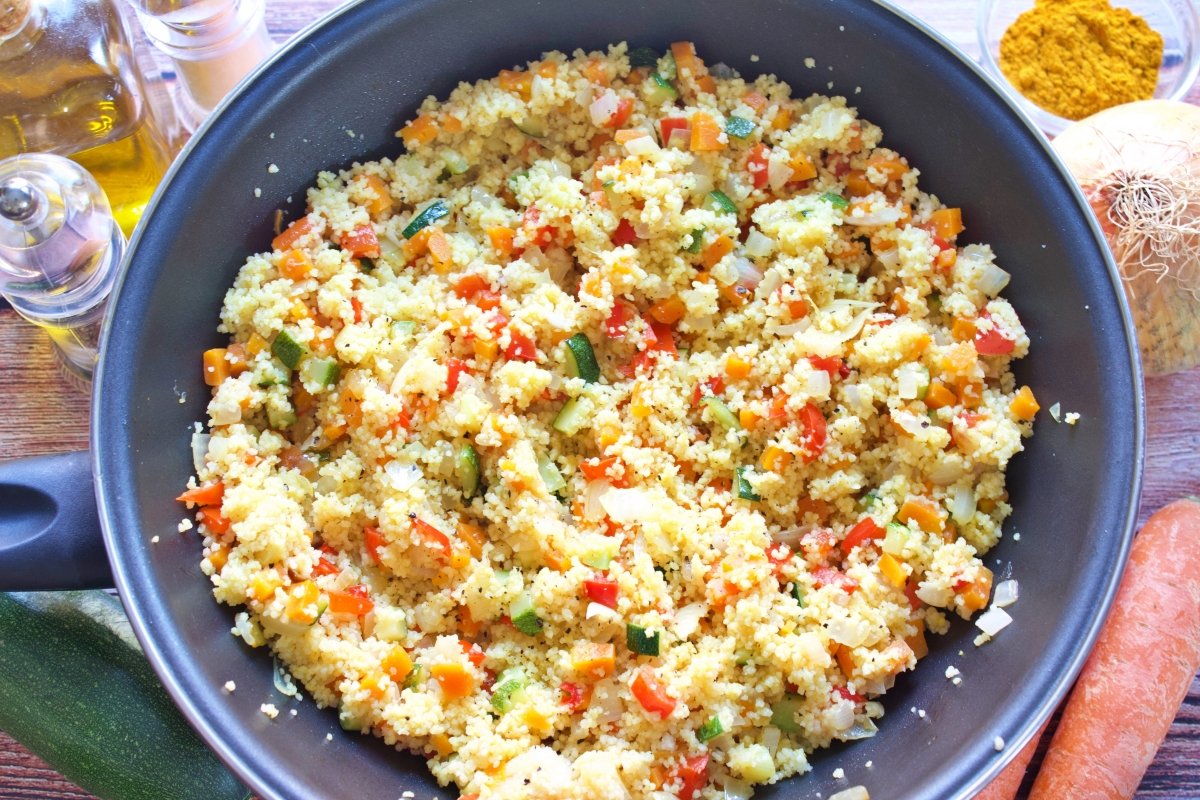 El cuscús de verduras con todos los ingredientes mezclados en una sartén