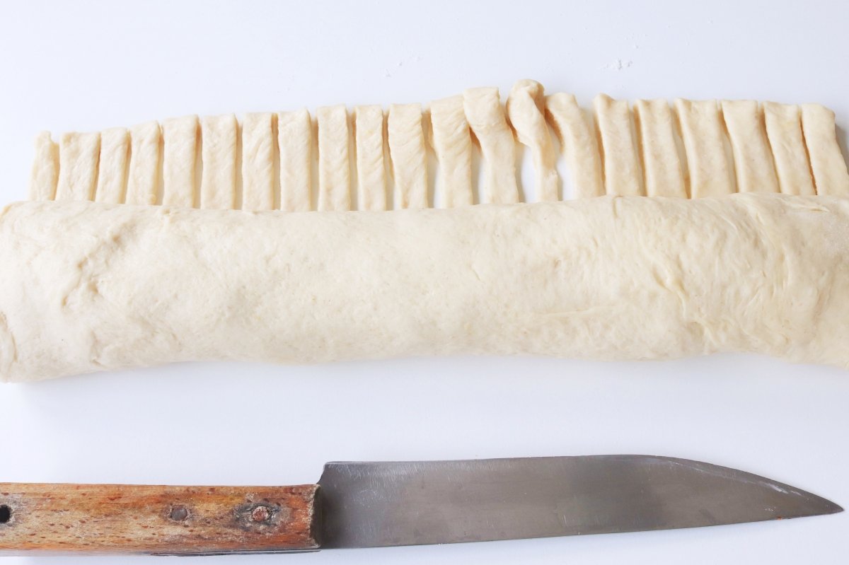 Roll up and make decorative cuts in the ham bread