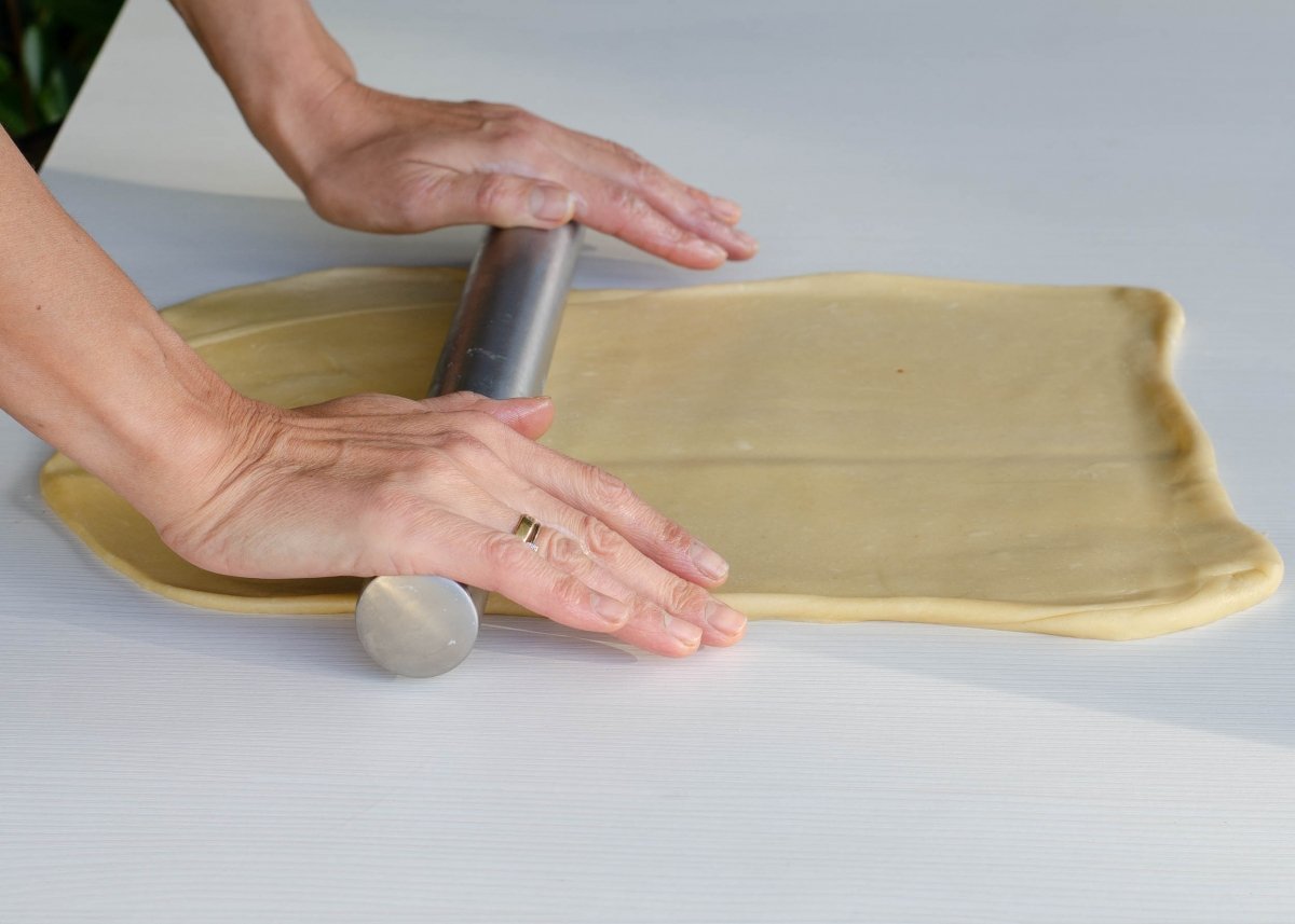 Rolling out the dough to spread the butter of the Mallorcan ensaimada