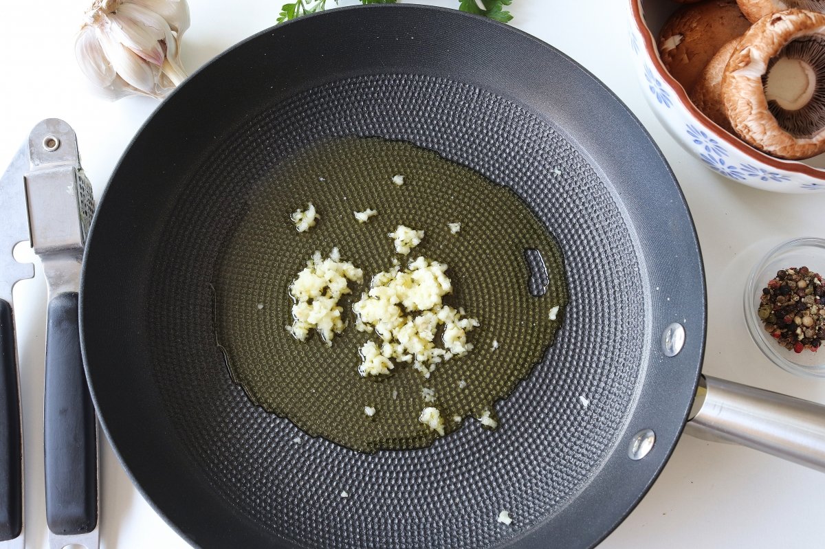 Freír ajos champiñones en salsa verde