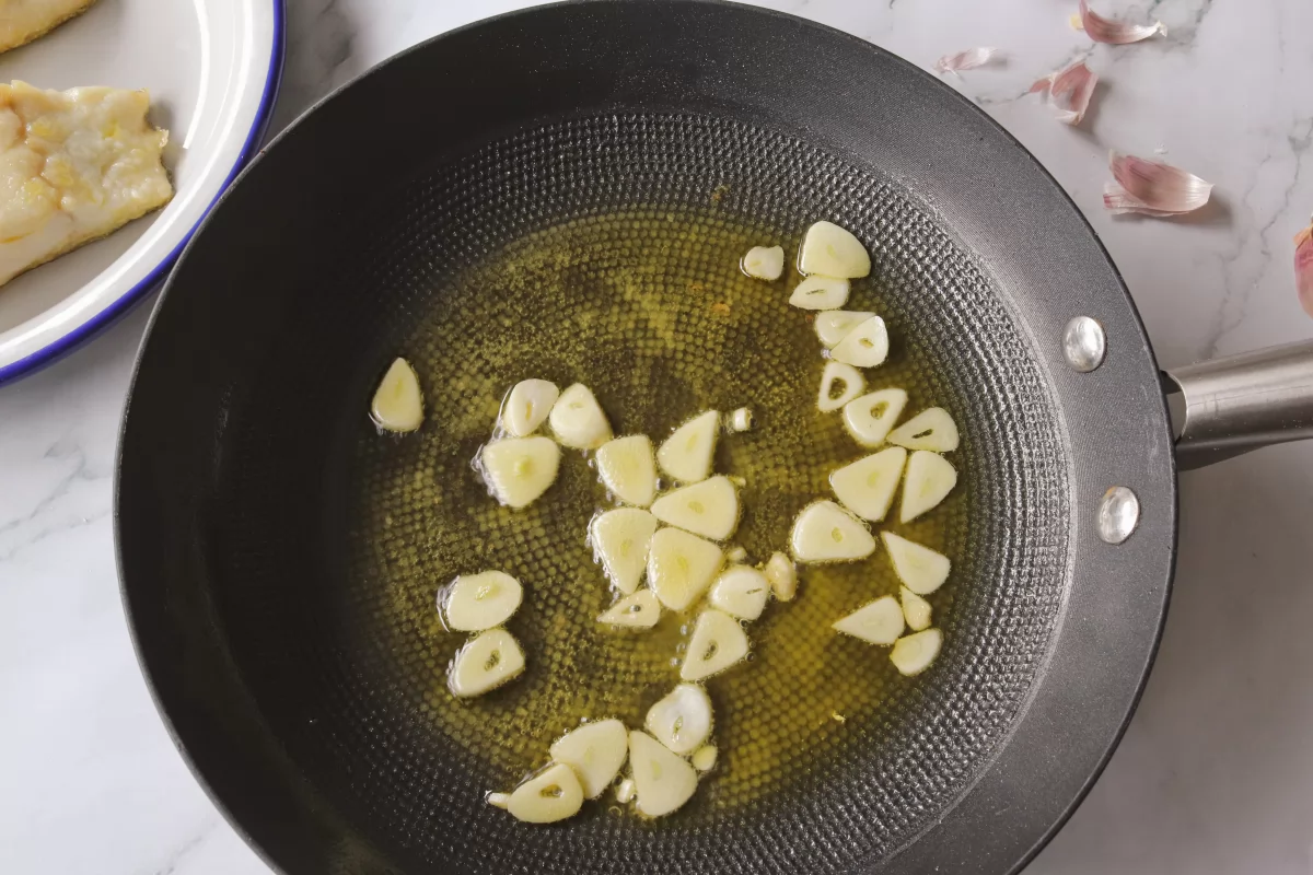 Freír los ajos para el bacalao a la llauna