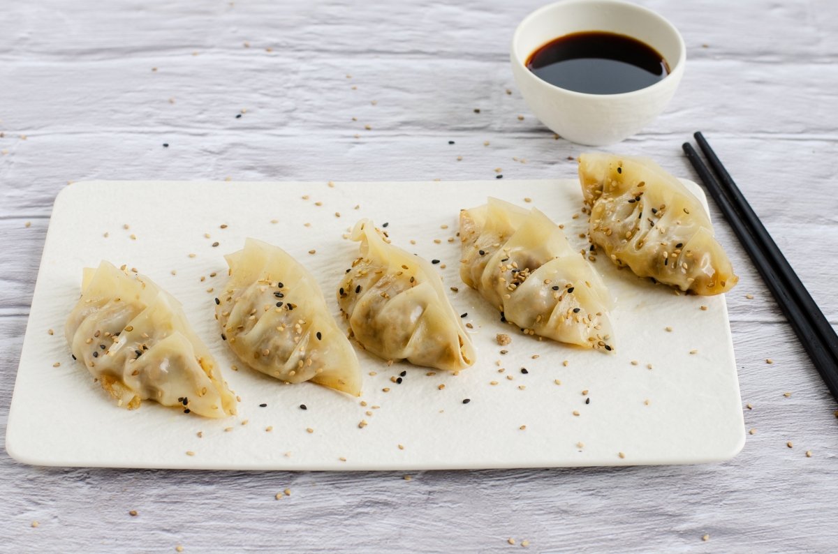 Gyozas served on a platter with soy sauce