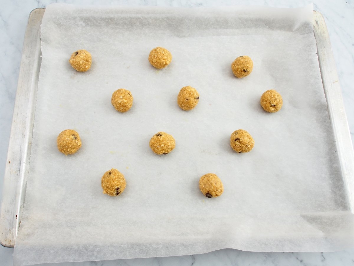 Roll the oatmeal chocolate cookie dough into balls.