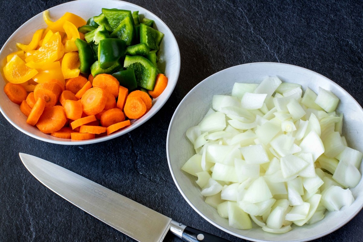 Lavar, pelar y cortar las verduras para el estofado de pollo con patatas y verduras