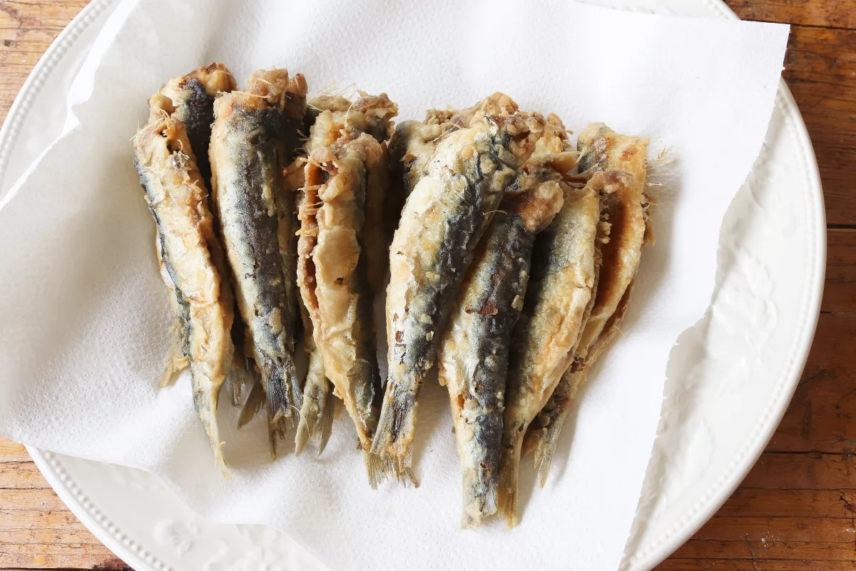 Llevar a papel absorbente las sardinas fritas