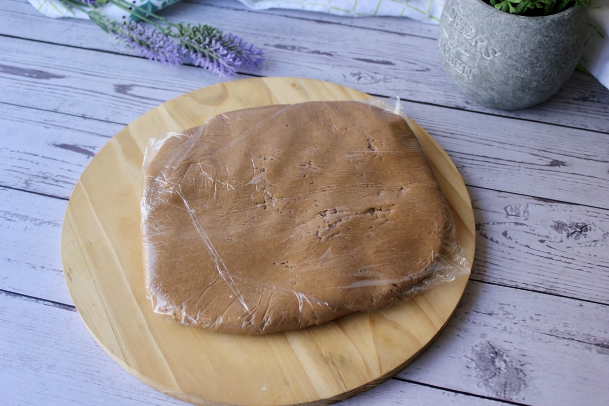 Raw cinnamon cookie dough wrapped in cling film
