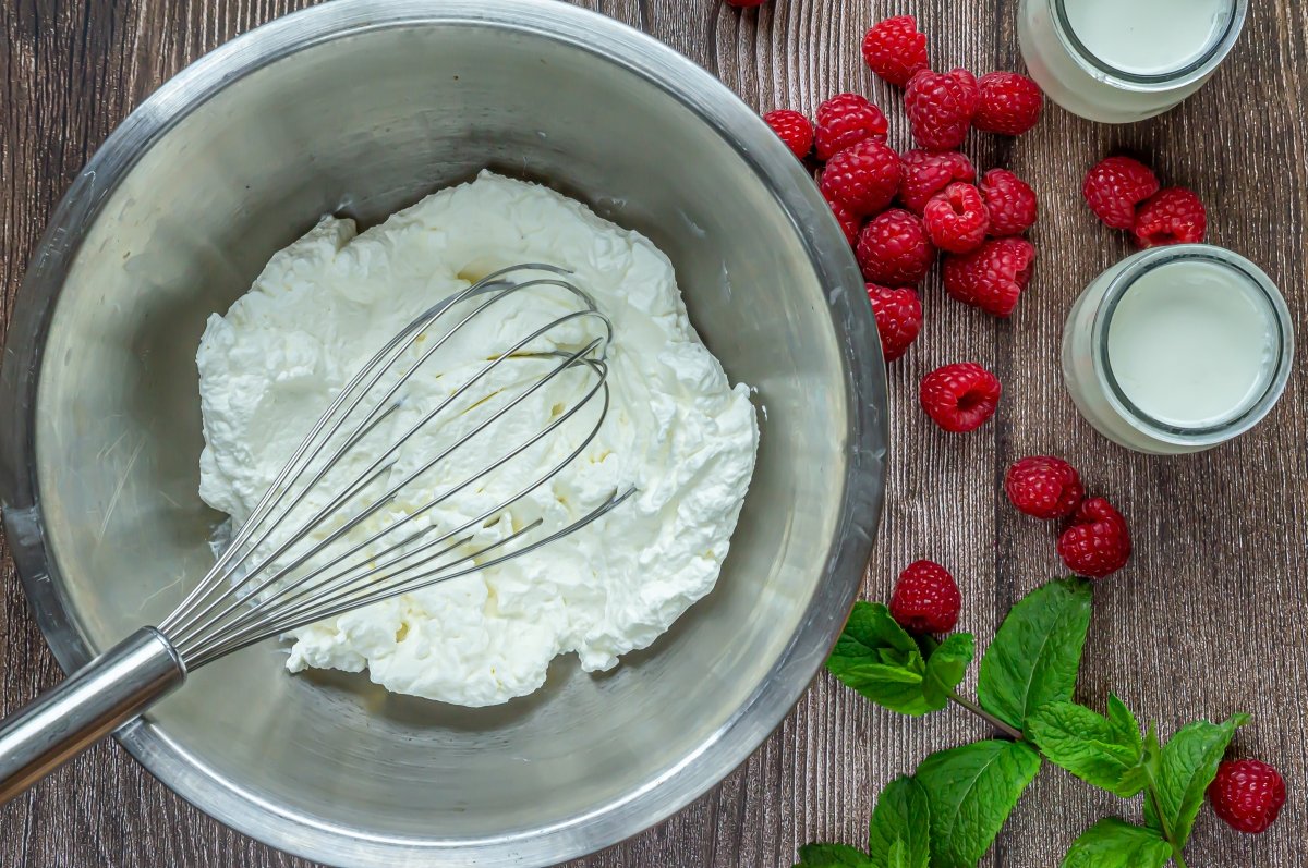 Whip the cream for the yogurt ice cream