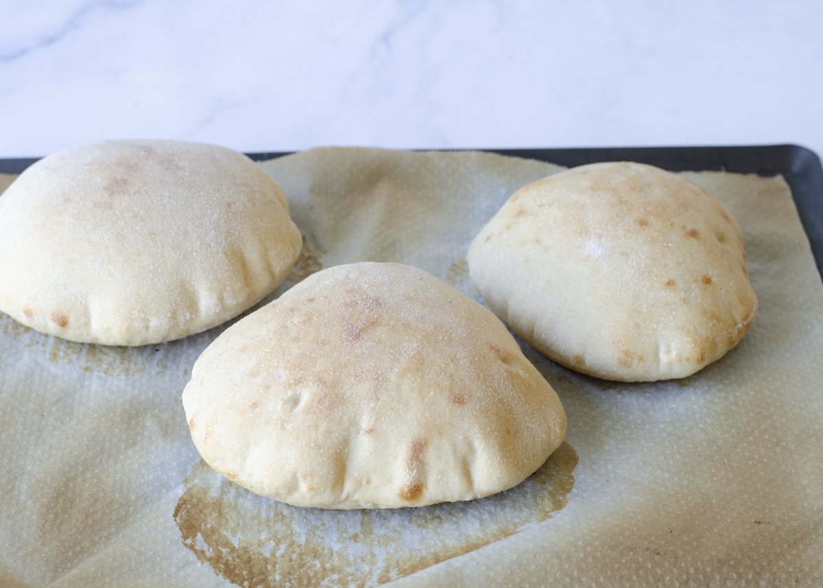 Pita breads on the baking sheet