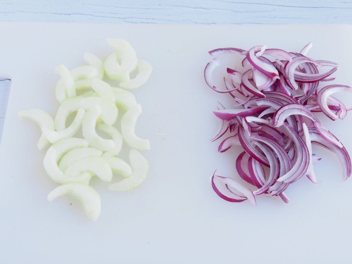 Pelar y cortar en medias lunas el pepino y la cebolla morada