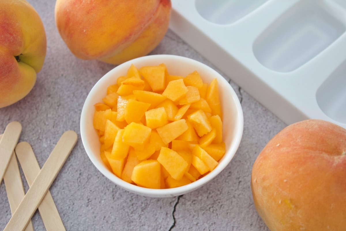 Chopping a peach to make the peach popsicles