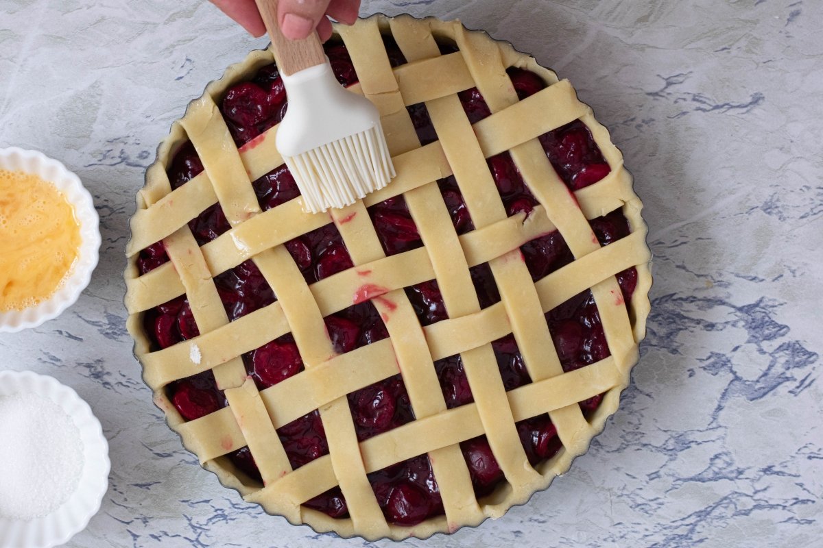 Brush cherry pie or American cherry pie with beaten egg