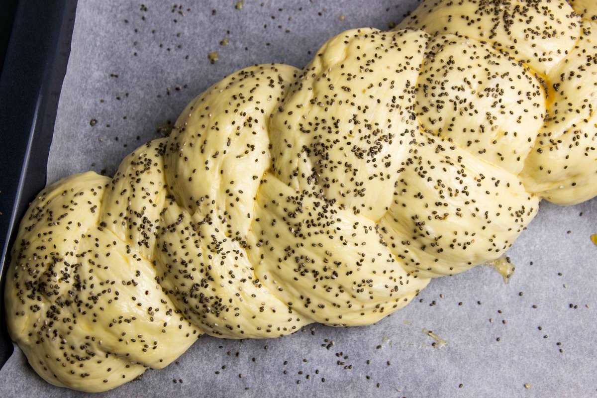 Brush with egg and sprinkle chia seeds on the braided Challah bread before baking