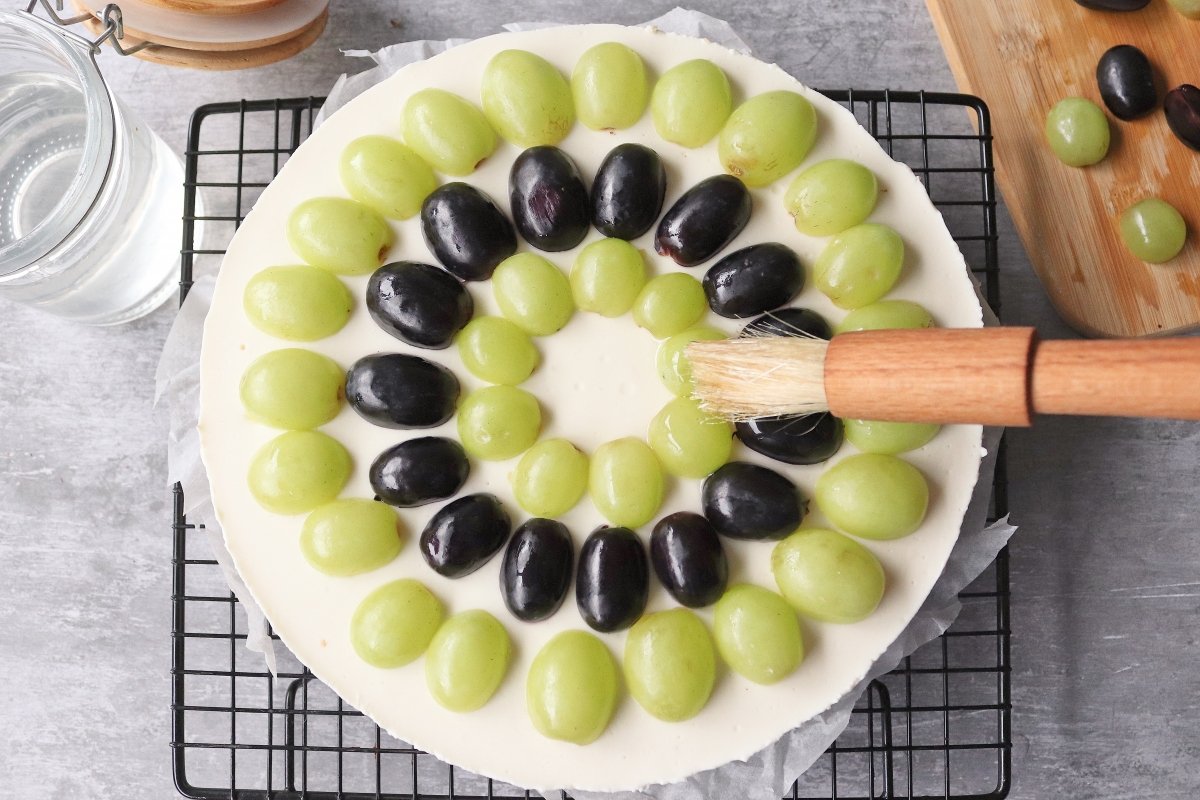 Paint cheesecake and grapes with syrup