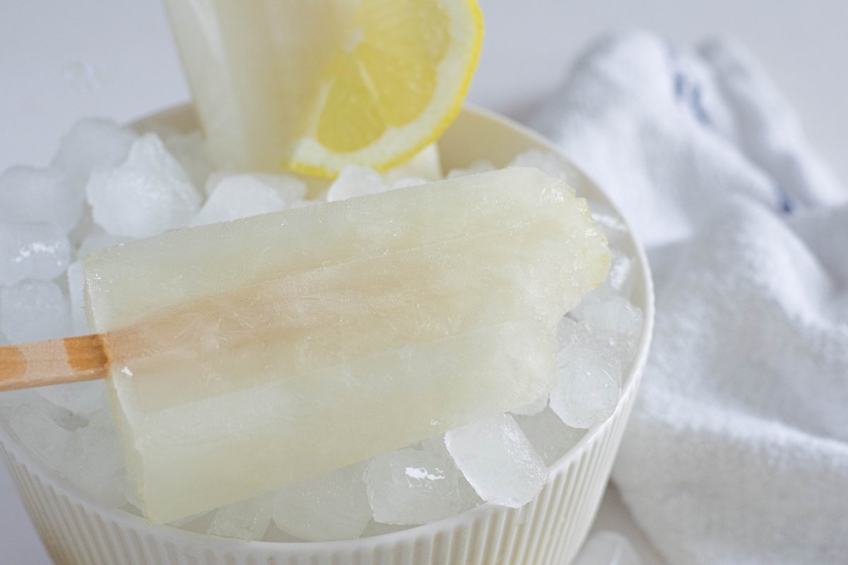 Homemade lemon popsicles on ice