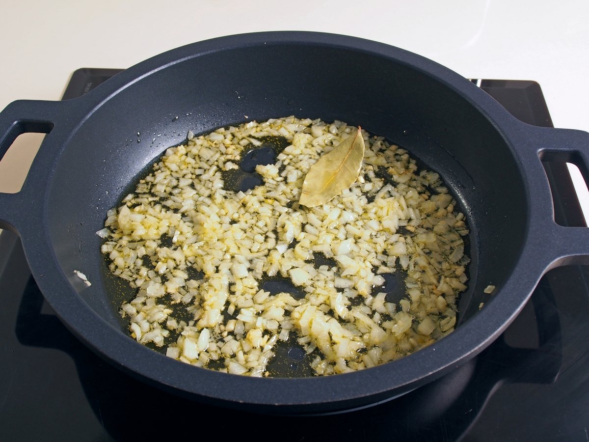 Poner una tartera con aceite de oliva y sofreír el ajo y cebolla