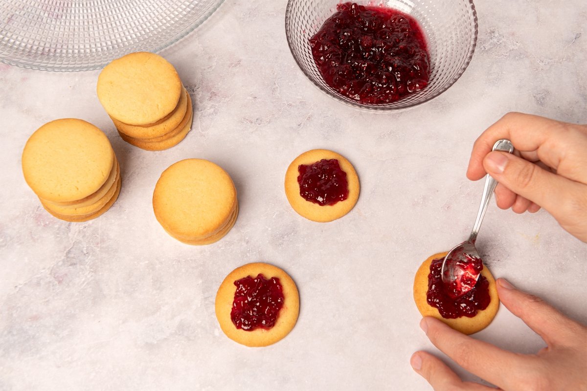 Putting jam on the oxeye cookies