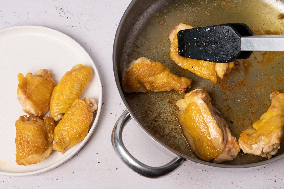 Proceso de dorado de los trozos de pollo para hacer arroz con pollo